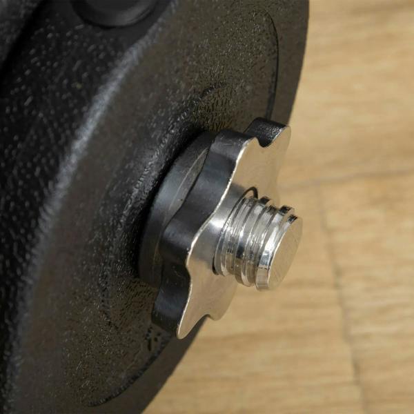 Close-up of black weight plate with threaded screw stud and steel rod end