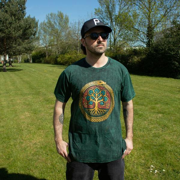 Green stonewashed cotton T-shirt with Tree of Life print worn outdoors