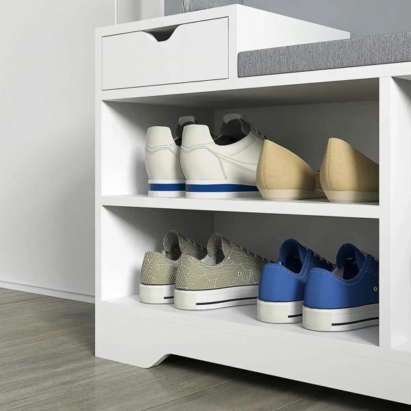 White shoe bench showing open shelves with shoes under a gray cushioned top