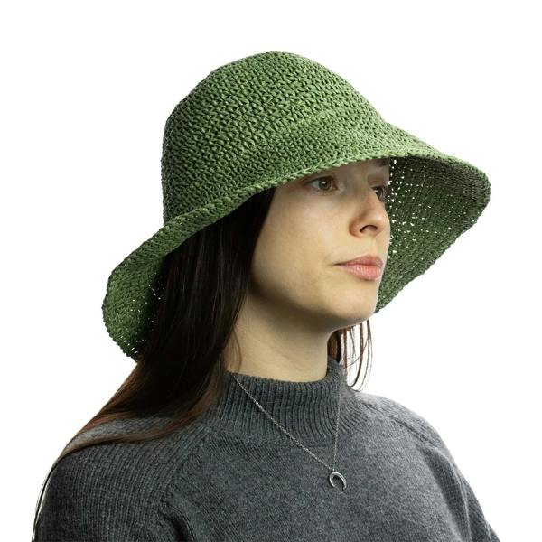 Moss green floppy straw sun hat on model, side view with relaxed crown