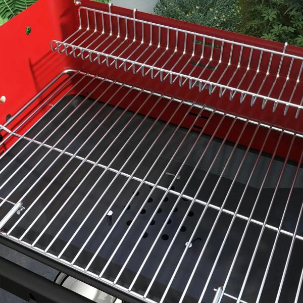 Red grill interior with wire cooking grate and metal warming rack