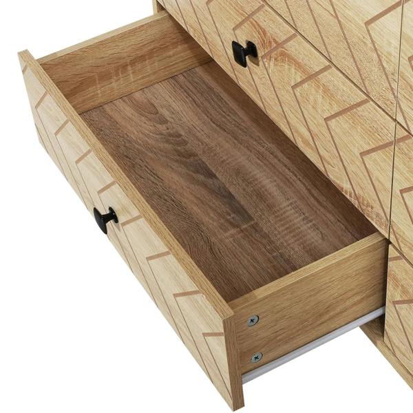Open drawer of natural 6-drawer dresser with zigzag front and black handle, empty interior.