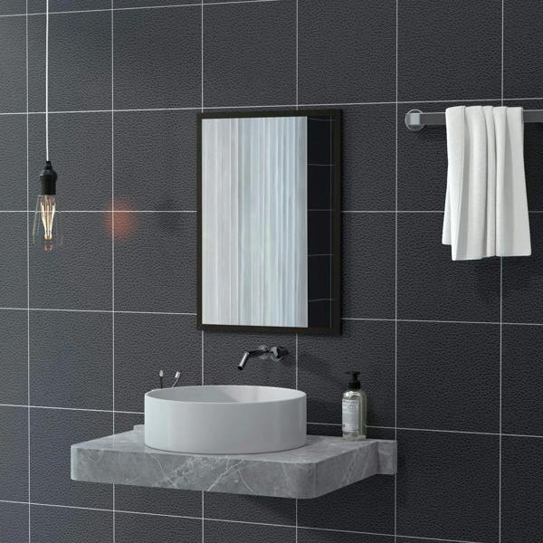 Black-framed wall mirror over a white vessel sink in a dark tiled bathroom