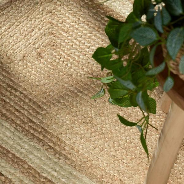 Close-up of a woven mat with a plant on top