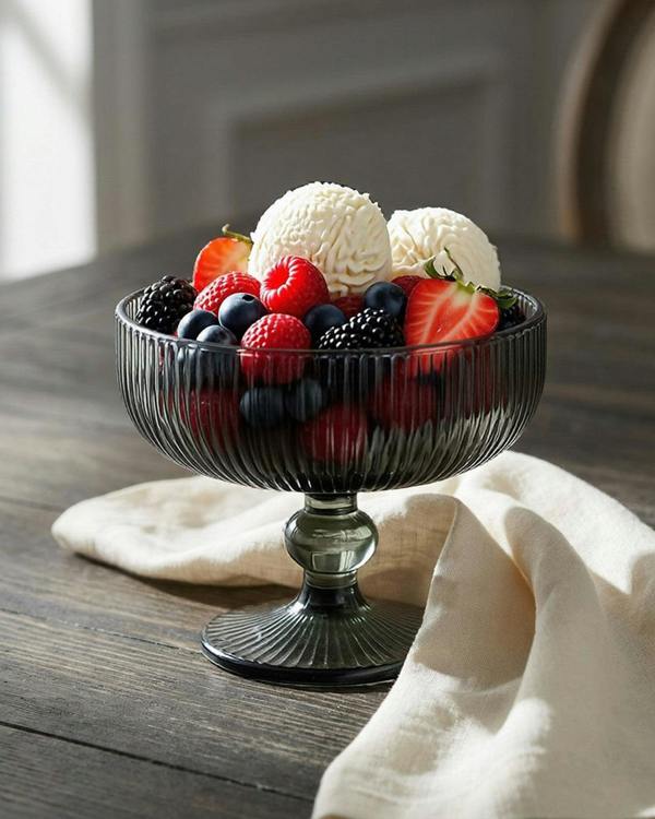 smoked glass dessert bowls on a wooden surface with decorative elements.