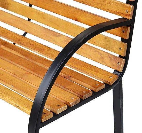 Close-up of natural wood slats and black curved armrest on garden bench