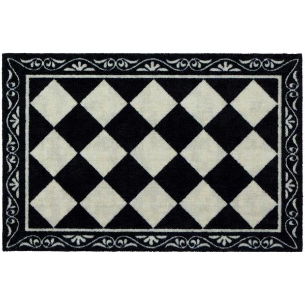 Black and white checkered rug with decorative border on a white background