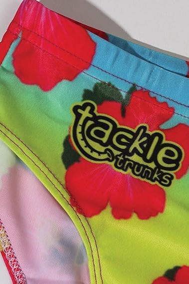 Optimum Tackle Trunks swim brief, close-up of tackle trunks logo on neon hibiscus floral waistband - Optimum