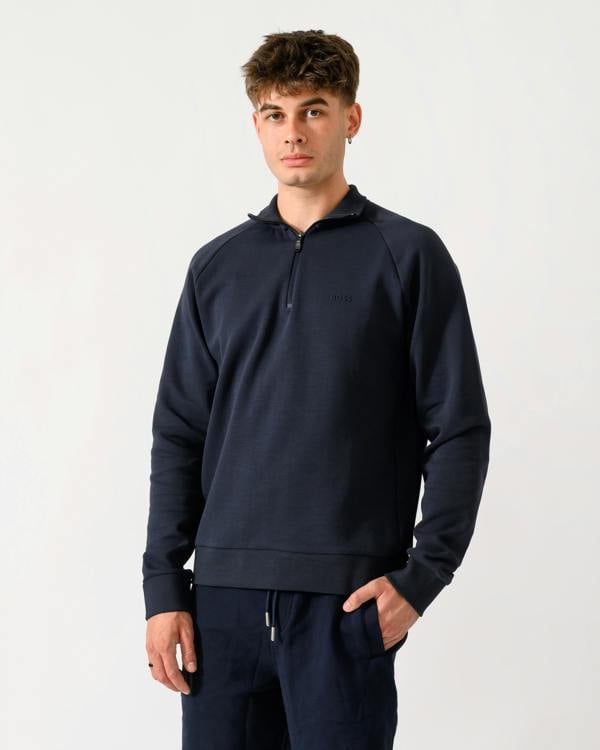 mid shot of a model wearing a BOSS Green Sweat Mens quarter Zip Sweatshirt in Dark Blue 402