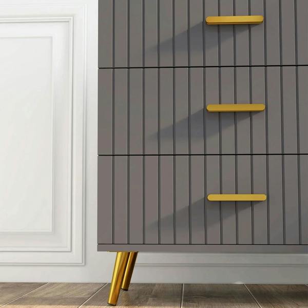 Dark grey dresser front corner with embossed vertical lines, gold-tone bar handles and gold legs
