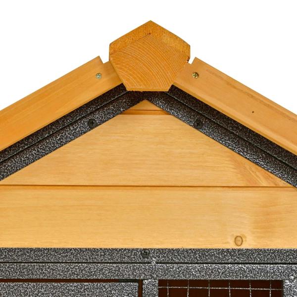 Close-up of guinea pig hutch roof corner with wood panels and textured underlayer