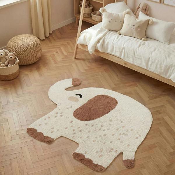 Children's room with a large elephant-shaped rug on a wooden floor.
