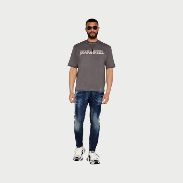 Supplied Fashion grey loose fit cotton t-shirt with faded cartoon logo worn by a model with sunglasses and jeans