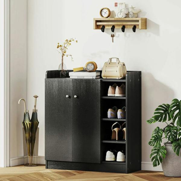 Black shoe storage cabinet with two doors and open shelving with stored shoes