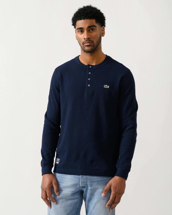 model wearing a Lacoste Boxy Tunisian Neck Mens Knit T-Shirt in Navy Blue 166