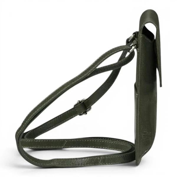An green leather crossbody bag with a long adjustable strap, shown from a side profile view against a plain white background.