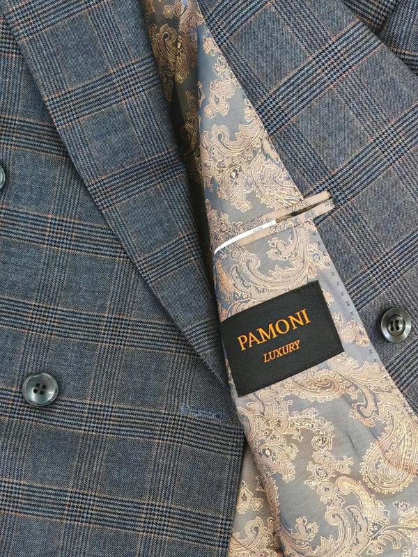 Close-up of a double-breasted suit jacket in a blue-gray plaid pattern, paired with a matching paisley necktie. A black brand label reading 'PAMONI LUXURY' is visible on the tie.