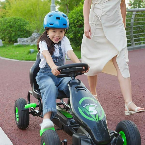 Kids pedal go-kart in black with green front panel, child riding with hands on handlebars.