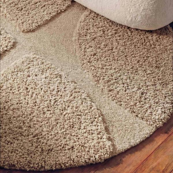 Beige shaggy rug on a wooden floor