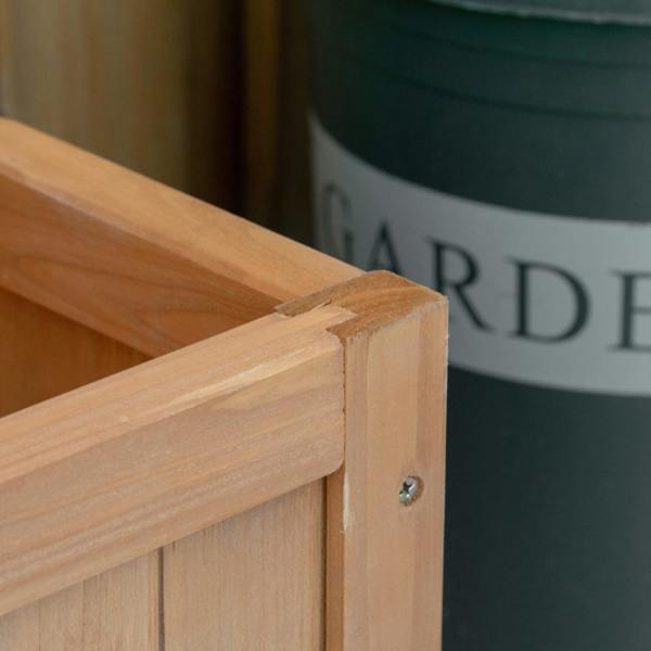 Close-up of brown wooden raised planter corner joint with metal fastener