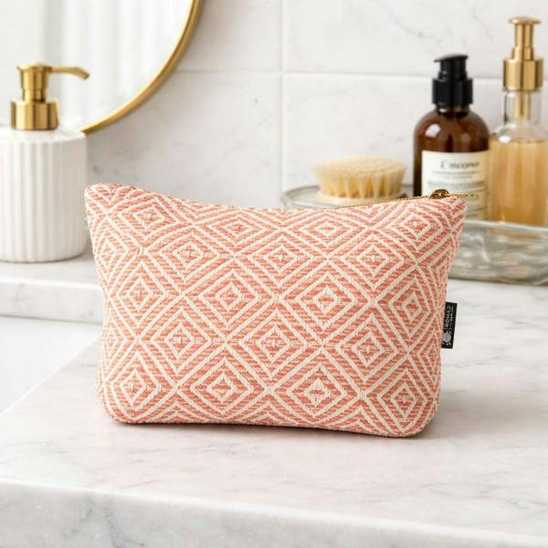 Coral diamond jacquard toiletry bag on marble surface with zipper