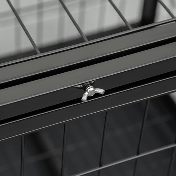 Close-up latch and metal frame on a black wheeled dog crate