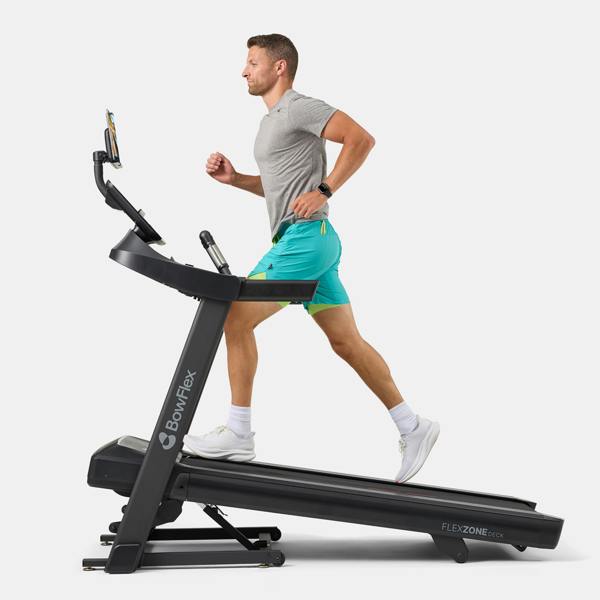 Man running on a BowFlex T6 treadmill, shown from the side on a white background.