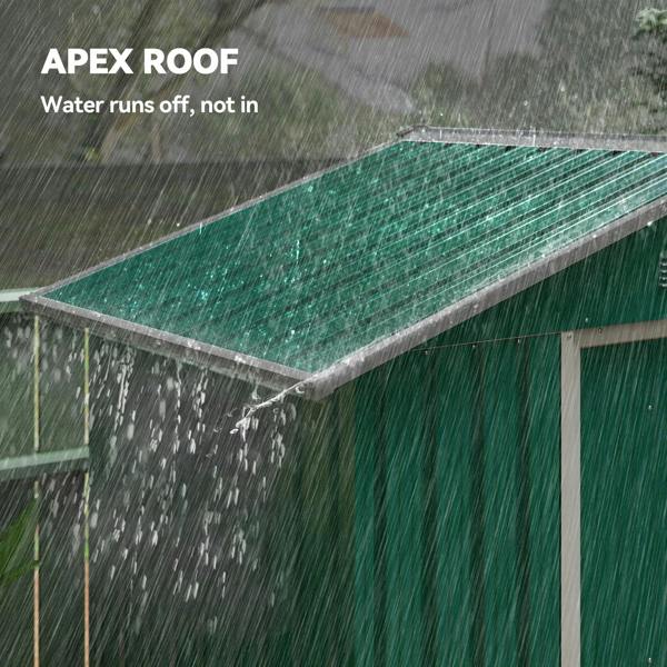 Green metal garden shed with apex roof shedding water during heavy rain