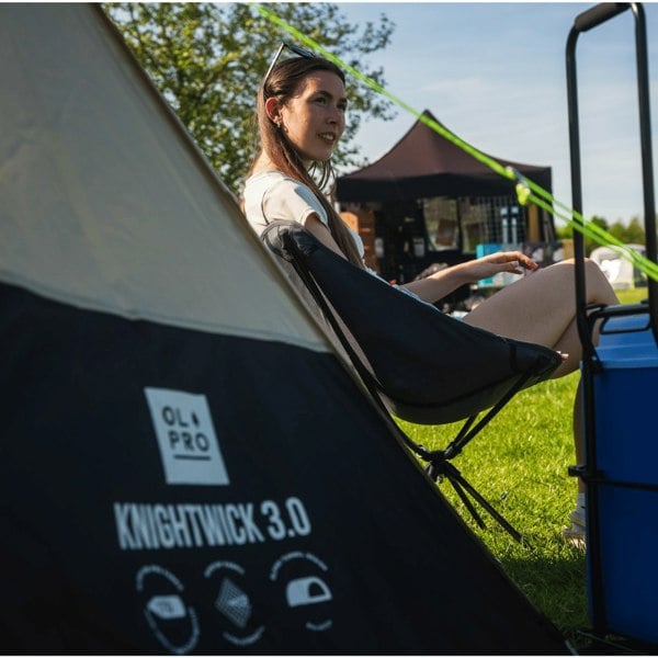 Knightwick 3.0 3 Berth Tent with its name on display and a young woman sat in the background on an OLPRO camp chair