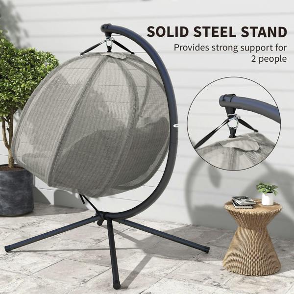 Grey hanging egg chair with blue handle bar, beige cushion, and black steel stand.