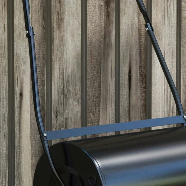 Black lawn roller with blue frame bars and curved handle against fence