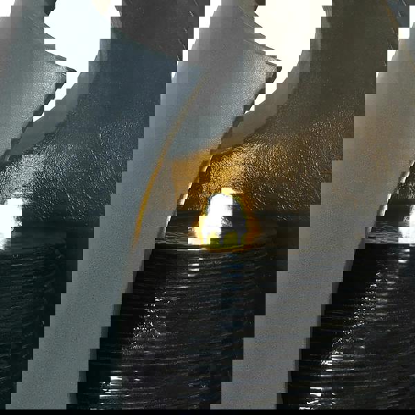 Sleek gray electric water feature with cascading falls, illuminated by a warm light, creating a tranquil ambiance in any space