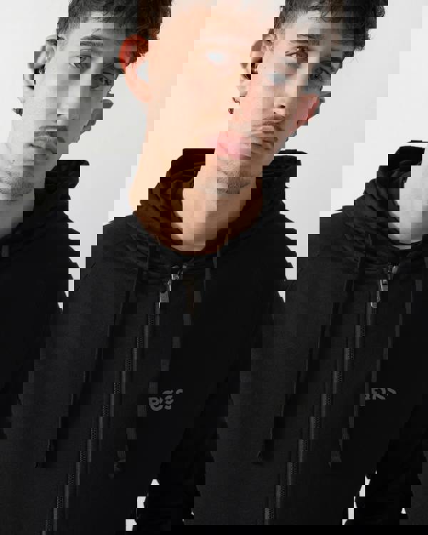 close up shot of a model wearing a BOSS Orange Mens Authentic Zip Up Loungewear Hoodie in Black 004