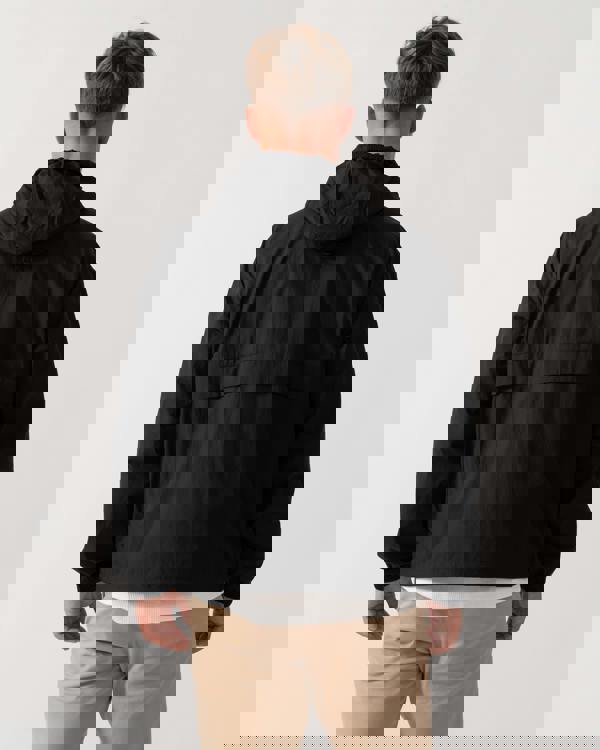 Model wearing Lacoste Lightweight Packable Water-Repellent Ripstop Jacket in Black 031 - Back