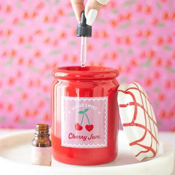 Red cherry jam-style wax warmer jar with wick insert at top