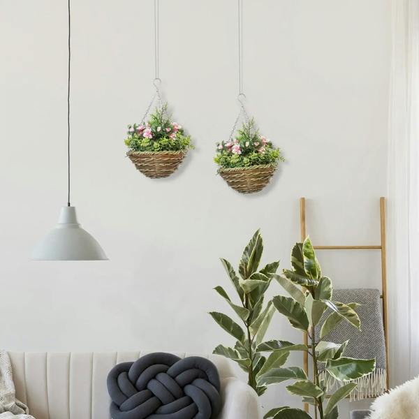 Two hanging wicker flower planters with pink blooms and green foliage, suspended by chains