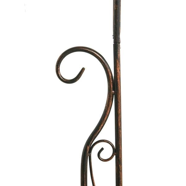 Black metal trellis detail with curved vine scroll on a vertical support bar