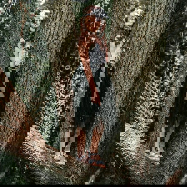 Flower girl playing in tree
