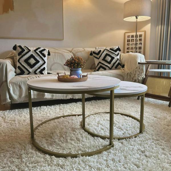 Round white marble-look coffee table with gold metal frame and base ring