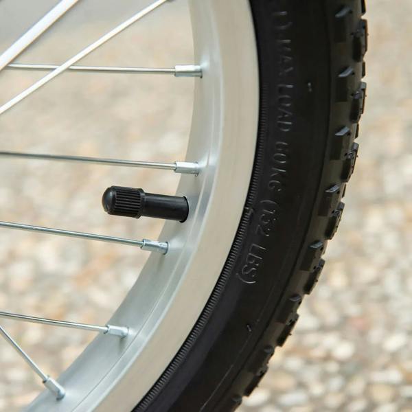 Close-up of black inflatable tire on metal wheel spokes
