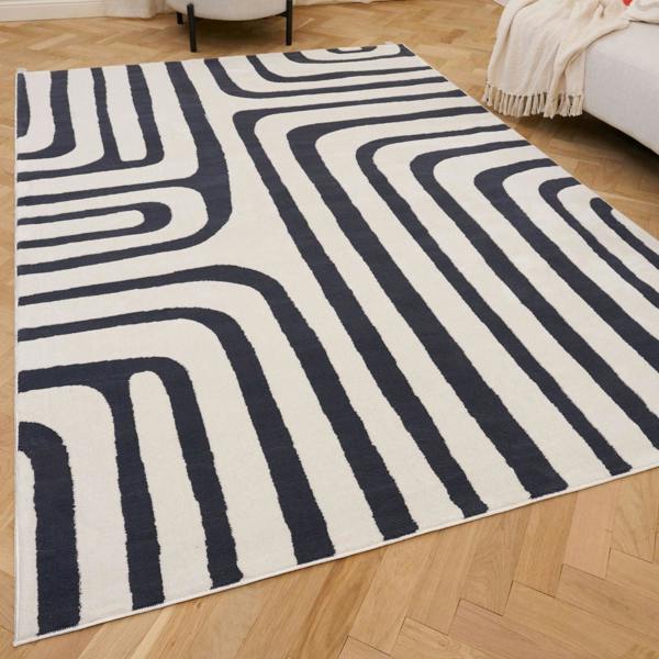 Navy and white geometric patterned rug on a wooden floor