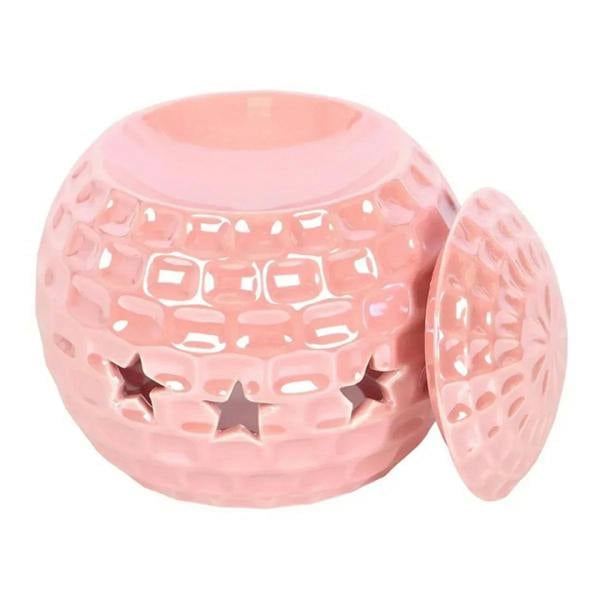 Pink oil burner with star cutouts, domed lid, and side opening