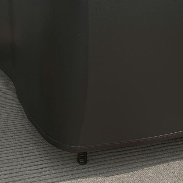 Close-up of black L-shaped furniture cover hem with stitched edge and grommets