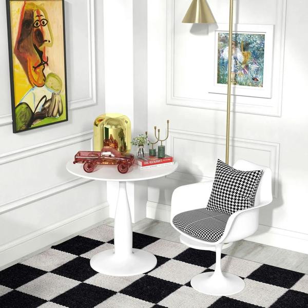 White round dining table with pedestal base, centerpiece decor on top
