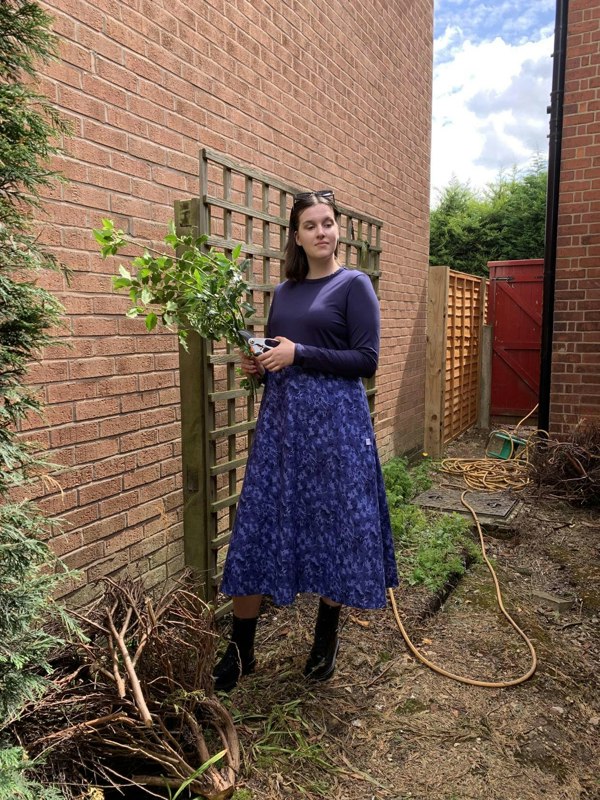 Pictured is the Amiira Dress in Colbalt Waves on our model who is 5"11 and wears a medium. This is the perfect dress for pottering around the garden but still feeling stylish. It is long sleeved navy top with a full patterned skirt. 