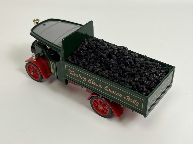 a toy truck with coal in it