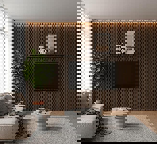 Modern living room with a wooden wall, TV, and decorative items with Smoked Oak acoustic slat panels.