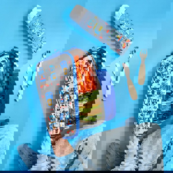 Lunchbox with robot designs containing carrots and sandwiches opened by a hand on a blue surface includes matching water bottle and utensils nearby jeans visible in corner