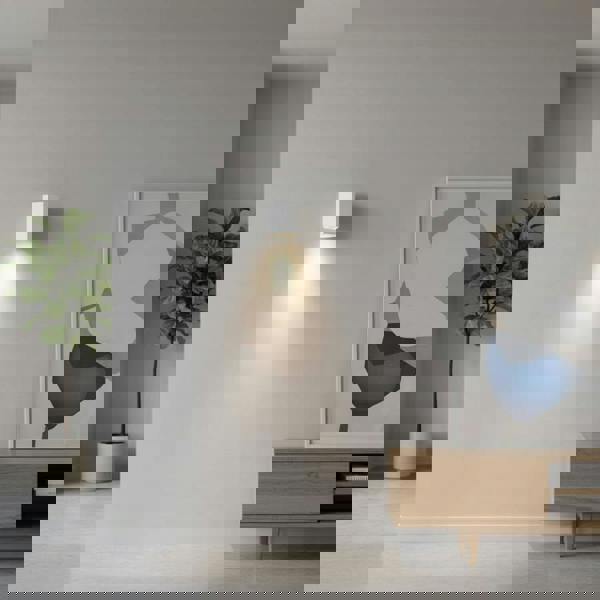 White indoor LED wall downlight on a light coloured wall in a lounge setting