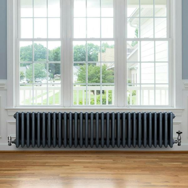 Traditional anthracite 4 column radiator, 300 x 1370mm, featuring a sleek design, installed beneath a large window with natural light